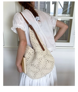 Detail of hand-woven cotton tote bag featuring floral crochet and brown leather strap