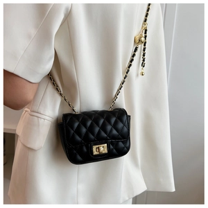 Detail of black quilted leather mini bag with gold chain and adjustable ball buckle
