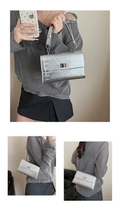 Detail of silver crocodile-embossed mini square bag with metallic turn-lock and chain strap