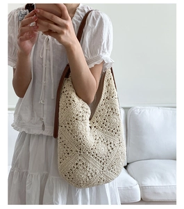 Detail of bohemian sunflower crochet bag with white cotton weave and brown leather strap