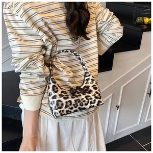 Detail of leopard print hobo bag with glossy finish and silver metal chain strap