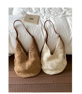 Detail of hand-woven hollow patterns on camel and cream crochet tote bags with leather straps