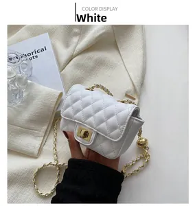 Detail of white quilted crossbody bag with gold twist lock and leather chain strap
