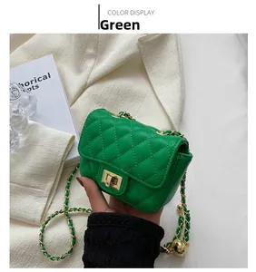 Detail of green quilted saddle bag with gold chain strap and metal lock closure
