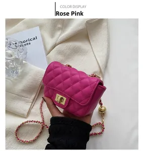 Detail of rose pink quilted mini crossbody bag with gold chain strap and turn-lock