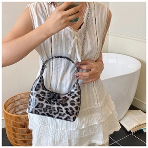 Close-up of leopard print shoulder bag with metallic chain strap and glossy finish