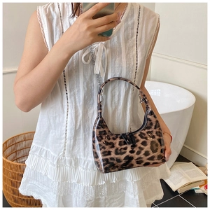 Detail of glossy leopard print hobo bag with silver chain strap and double zipper closure