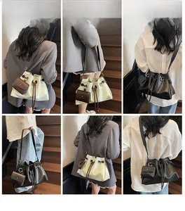 Detail of drawstring bucket bag showing detachable coin purse and metal ring hardware