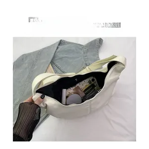 Interior view of white corduroy hobo bag showing spacious storage for essentials