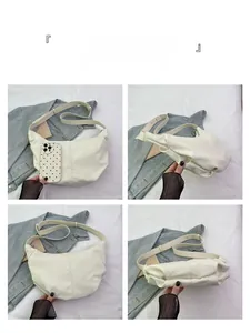 Multi-angle view of a creamy white corduroy dumpling bag with adjustable strap