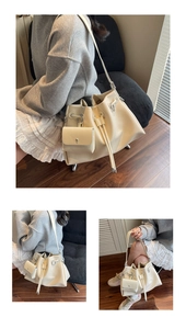 Detail of cream bucket bag with drawstring closure and matching small pouch on a strap