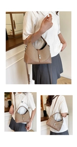 Detail showing brown woven dumpling bag with leather trim and silver metal buckle closure