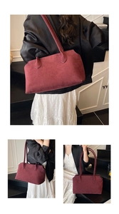 Detailed view of dark red suede tote bag texture with minimalist long handles and soft finish