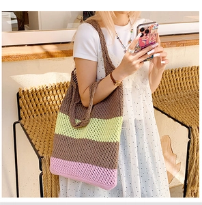 Detailed close-up of a tricolor striped crochet beach tote with delicate hollow mesh