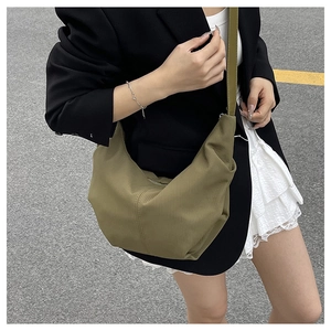 Detailed view of olive green crescent hobo bag with vertical ribbed nylon texture