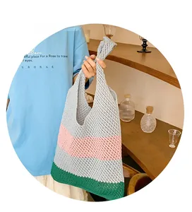 Detail showing the handmade knit texture and three-color stripe pattern on the tote bag