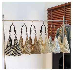 Detail of woven tote bags with hollow crochet texture and wooden bead handles in six colors