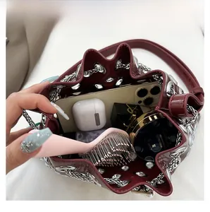 Close-up of wine red leather bucket bag interior showing spacious storage for cosmetics