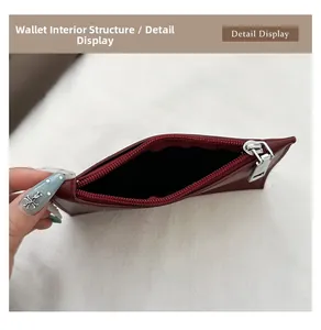 Detailed interior view of a dark red leather bucket bag featuring smooth metal zippers