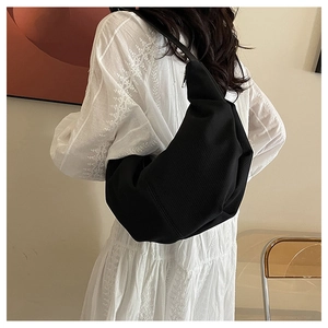 Detail view of black corduroy hobo bag showing striped texture and large capacity fit