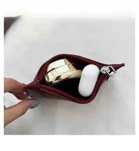 Close-up of small red leather bucket bag interior showing capacity for daily essentials