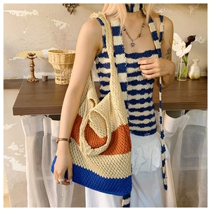 Detail of hand-woven striped tote bag in blue and orange for a vintage beach look