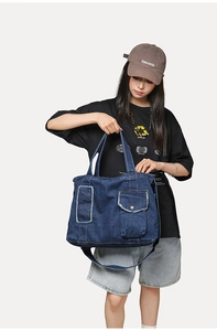 Détail du sac en denim bleu marine avec doubles poches et texture à bords effilochés
