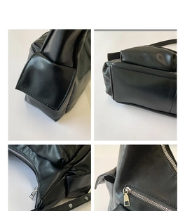 Close-up of matte black leather tote stitching and silver metal zipper hardware details