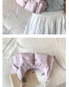Detailed view of lavender faux leather tote bag with functional silver zippers and pockets