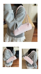 Détail du sac Boston rose clair en cuir PU mat avec de fines bandoulières élégantes