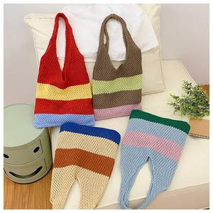 Detail of four colorful striped crochet tote bags featuring hollow knit texture and summer style