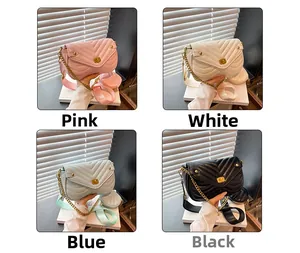 Detail of V-quilted faux leather crossbody bag with gold twist lock and mini coin purse