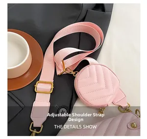 Detailed close-up of pink quilted mini round bag with adjustable fabric shoulder strap