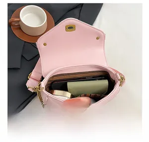 Pink quilted crossbody bag interior capacity showing phone and makeup accessories