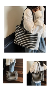 Detail showing high-capacity striped woven tote with textured straw fabric and black straps