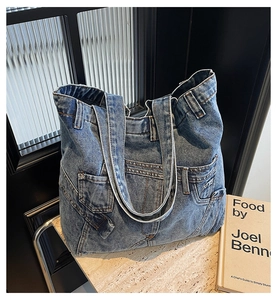 Detailed close-up of retro denim tote bag showing jeans-style pockets and stitching