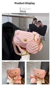 Detailed view of pink quilted handbag with V-stitch texture and round coin purse accessory