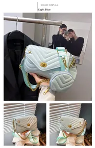 Detail of mint green chevron quilted crossbody bag with gold lock and mini coin purse
