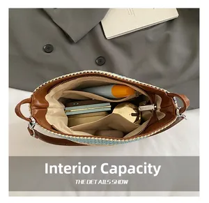 Top view of the large interior capacity of the woven shoulder bag with a zipper pocket