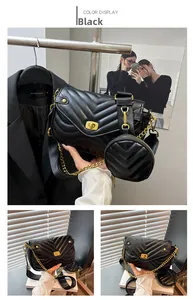Close-up of black quilted shoulder bag with gold V-shaped rotating clasp and hardware