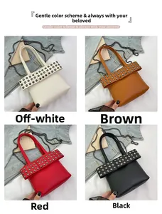 Close-up of studded handbags in beige, brown, red, and black with lychee texture