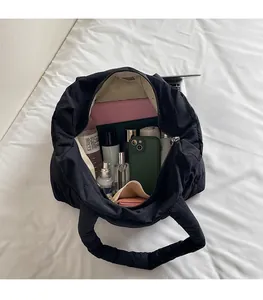 Top view of large black quilted tote bag showing spacious interior with laptop and essentials