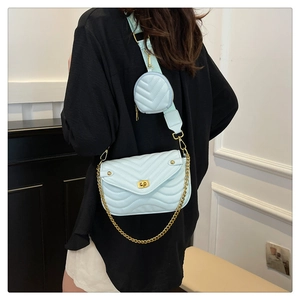 Detail of mint green quilted flap bag with gold lock and detachable round coin purse