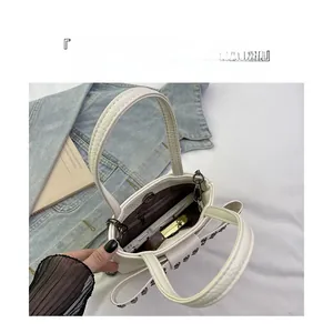 Macro view of interior storage with zipper pocket and metal rivets on leather bag