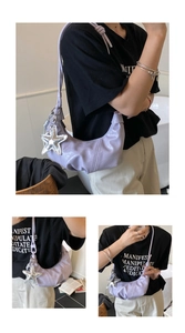 Detail of taro purple crescent bag with glossy patent leather and star charm