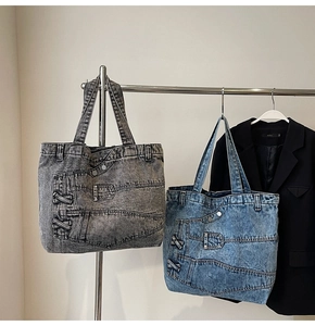 Detail of vintage denim tote bags in dark grey and blue with jeans-style pocket elements