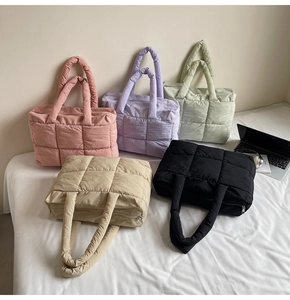 Detailed view of lightweight quilted down tote bags in five assorted pastel colors