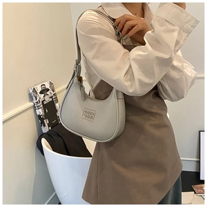 Detail of light gray lychee grain leather underarm bag with embossed square logo