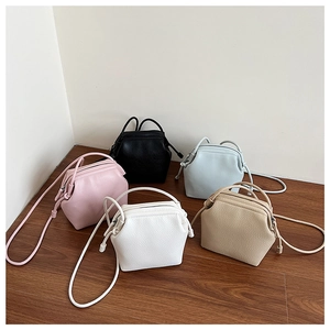 Group shot of five colorful leather crossbody bags in pink black blue white and khaki