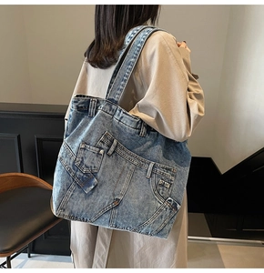 Retro denim tote bag featuring patchwork jean details shown as a large crossbody shoulder bag